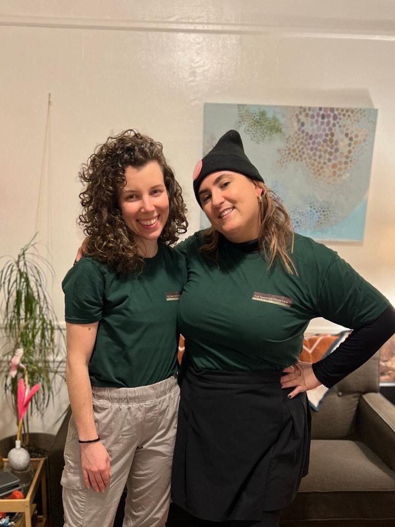 Bryen and Lauren standing in matching green Doula shirts