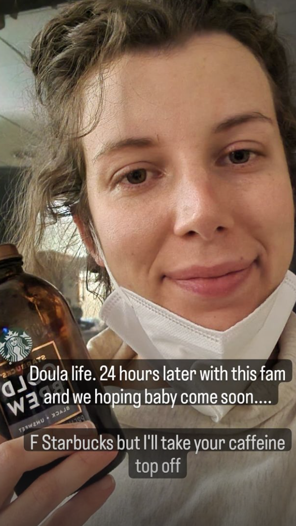 Bryen holding coffee to get through the Doula day (and night)